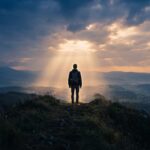 Silhouette di un giovane su una collina al crepuscolo: sentirsi disadattati e cercare la propria luce
